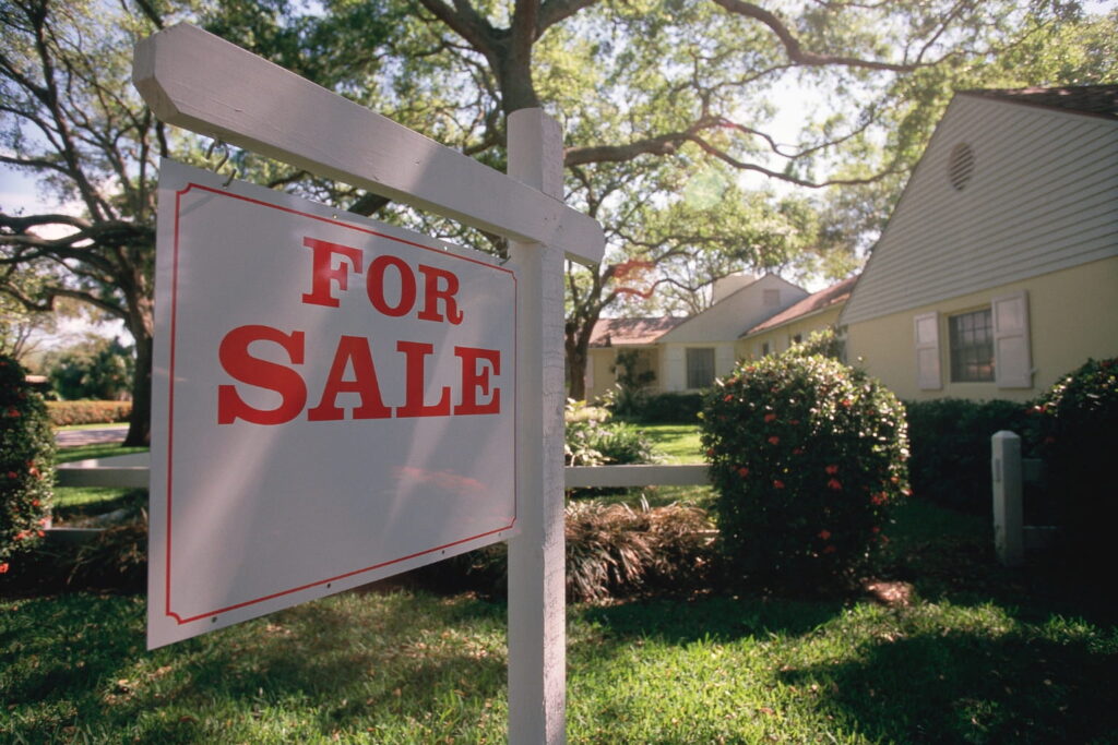 first-time homebuyer mistakes House for sale sign in front of home