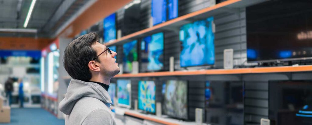man shopping for a TV