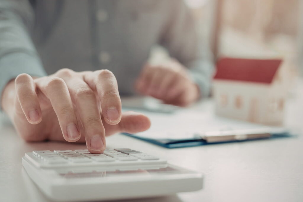 first-time homebuyer mistakes person using a calculator