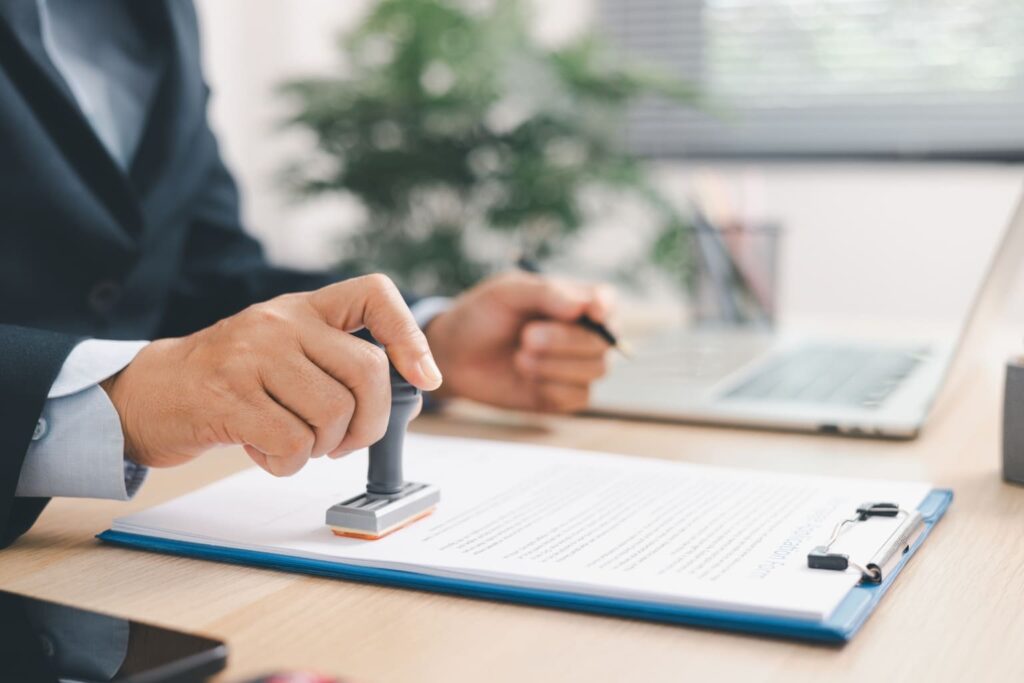 First-Time Homebuyer Mistakes a man stamping a document