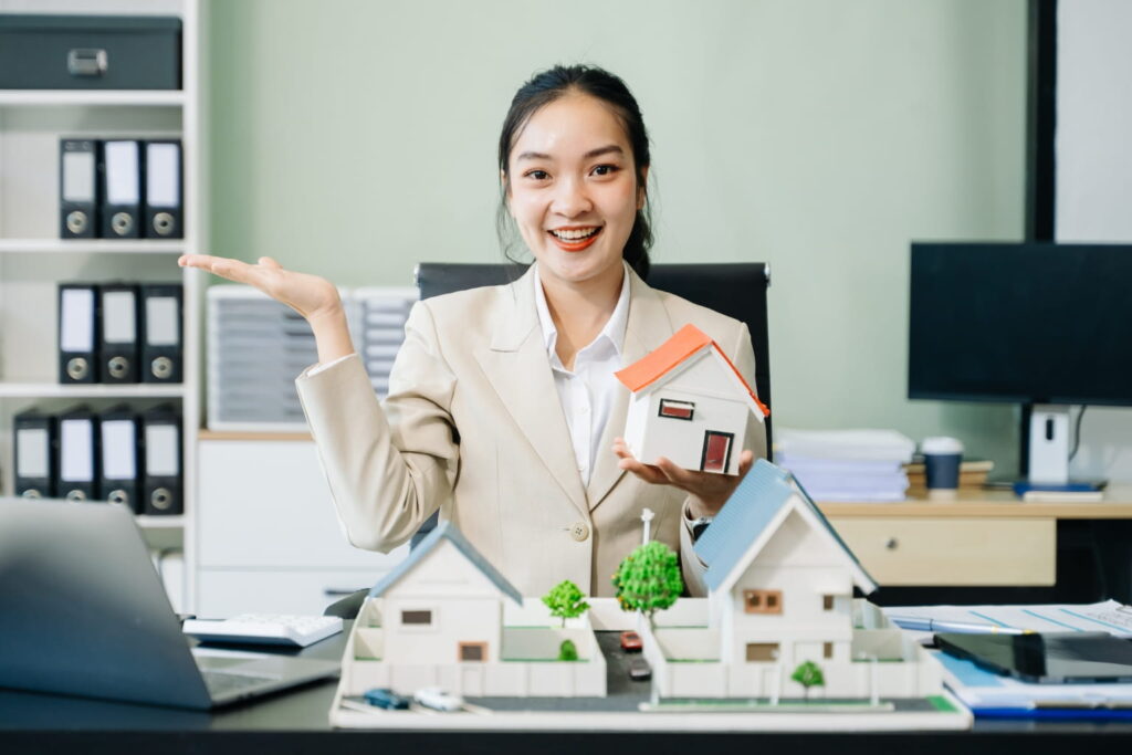 a real estate agent holding a house model