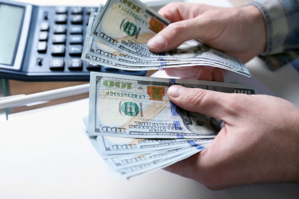 first-time homebuyer mistakes Close-up of hands counting money